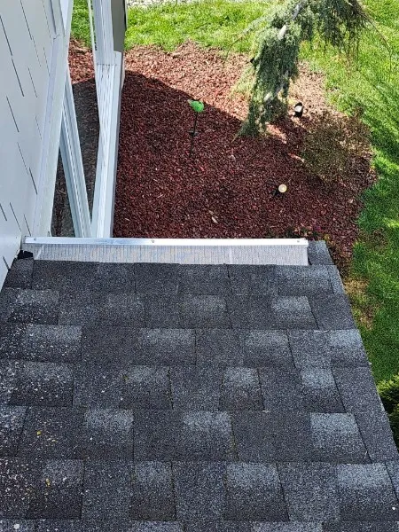 Gutter guard installed on corner section near landscaping