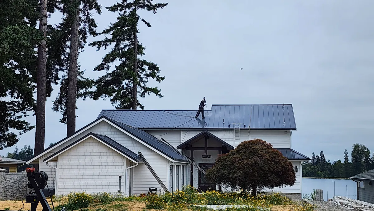 Professional metal roof cleaning in progress
